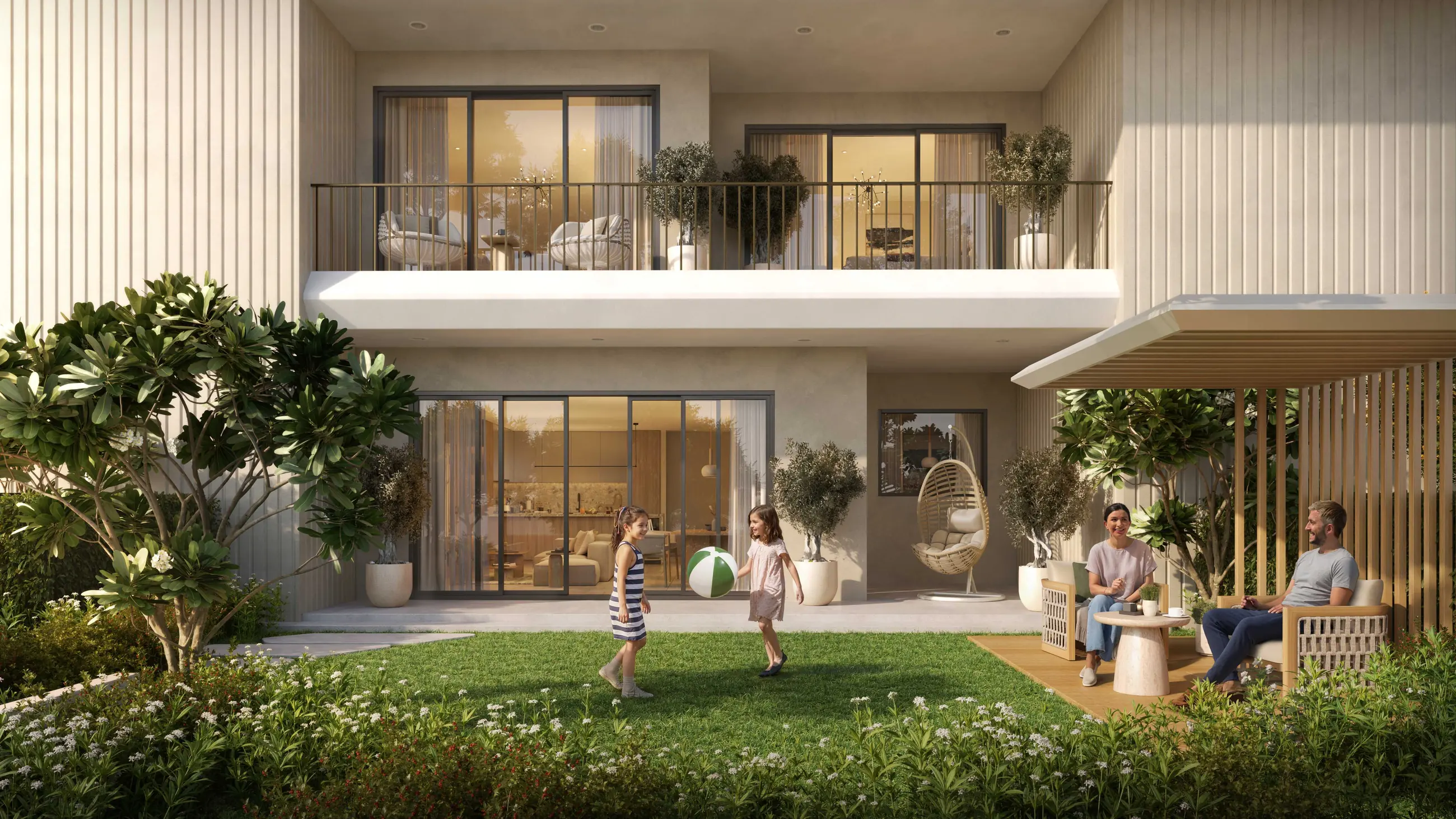 A family on the lawn outside a Yas Park Place ground-floor residence, with a landscaped courtyard beyond